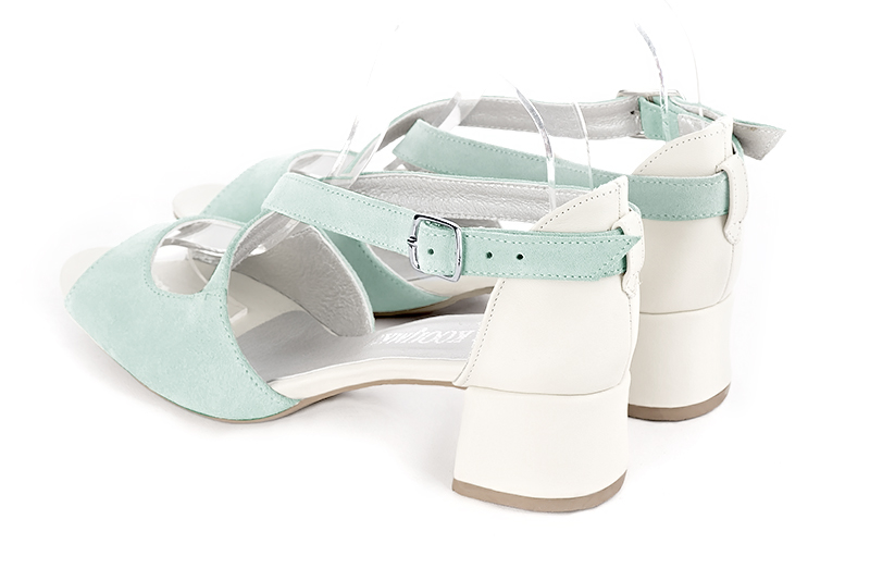 Aquamarine blue and off white women's closed back sandals, with crossed straps. Round toe. Low flare heels. Rear view - Florence KOOIJMAN